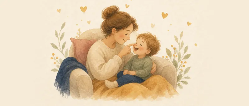 Mutter stupst ihr lachendes Kleinkind liebevoll auf die Nase im gemütlichen Sessel – Kosenamen für Kinder.